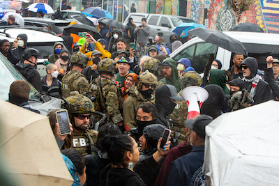 Photo of crowds of people protesting ICE raids